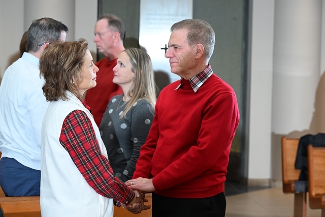 Group holding hands in church 