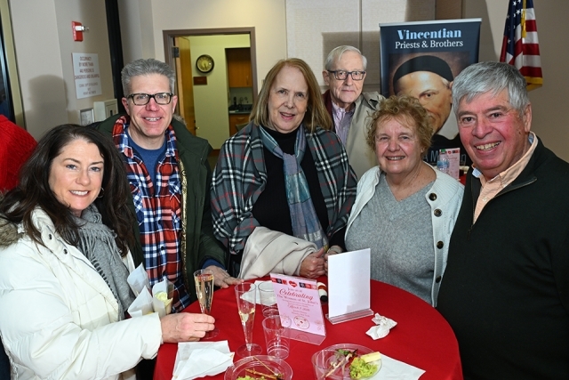 Group of men and women posing for a picture 