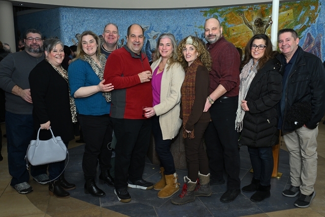 Group of men and women posing for a picture 