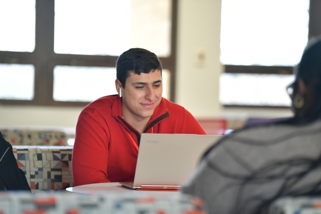 St. John's student on their labtop taking an online learning course 