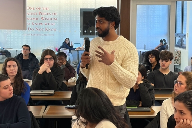 Student speaking in a crowd of other students 