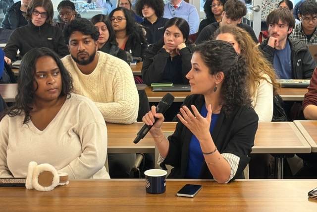 Student speaking in a crowd of other students 