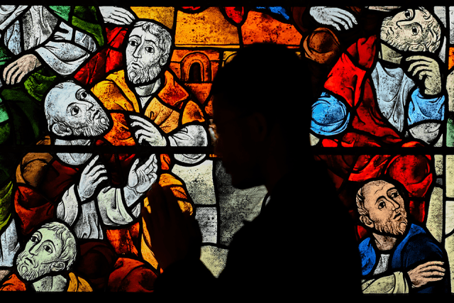 Shadowed Person praying in a church