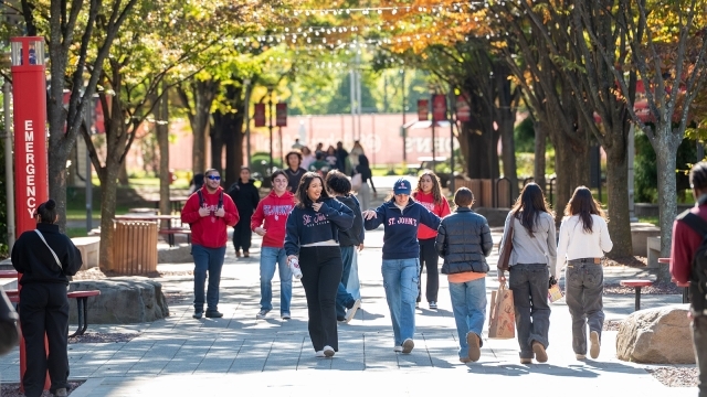 Students walking outside in the fall