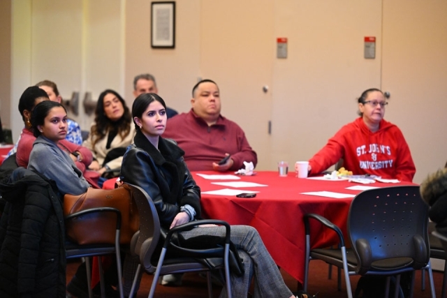Group of professionals listening attentively at a table 