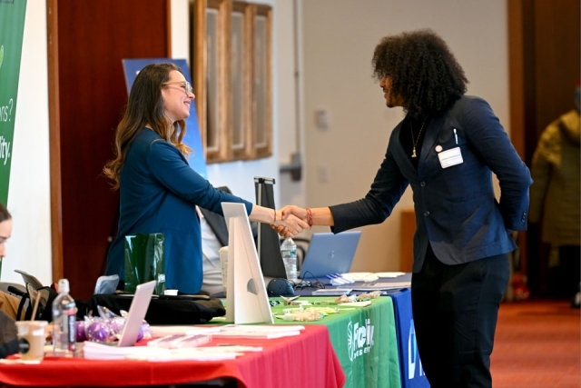 Women shaking another women's hand 