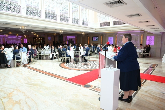 Woman speaking at a podium 