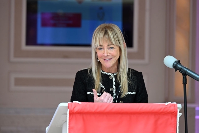Woman speaking at a podium 