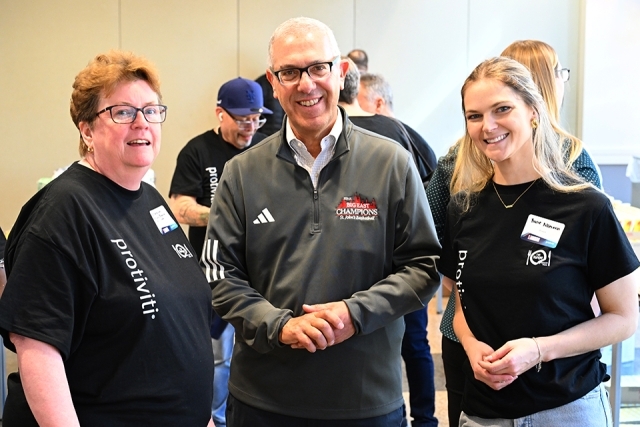 Three individuals smiling for photo 