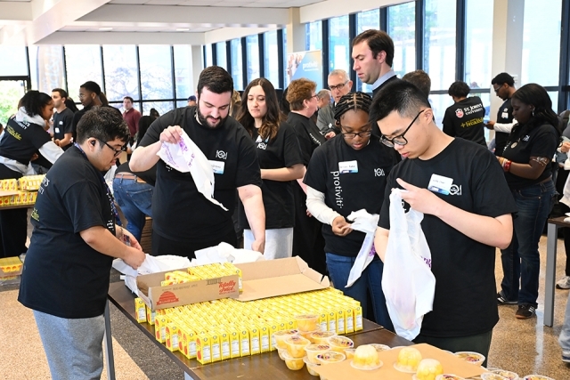 Students helping with food distribution at event 