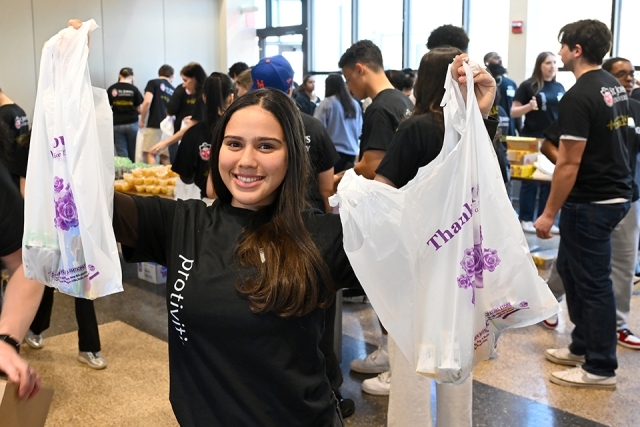 Students helping with food distribution at event 