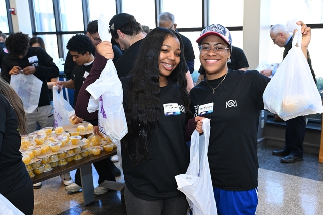 Students helping with food distribution at event 