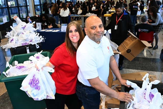 Woman and man helping with food distribution at event 