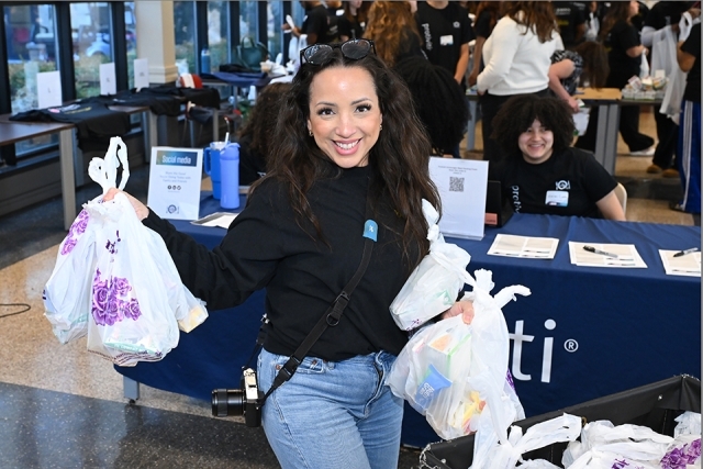 Student helping with food distribution at event 
