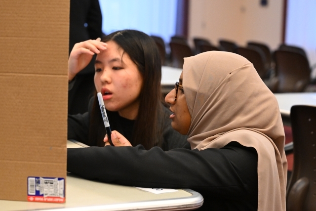 Two woman posing for a photo 