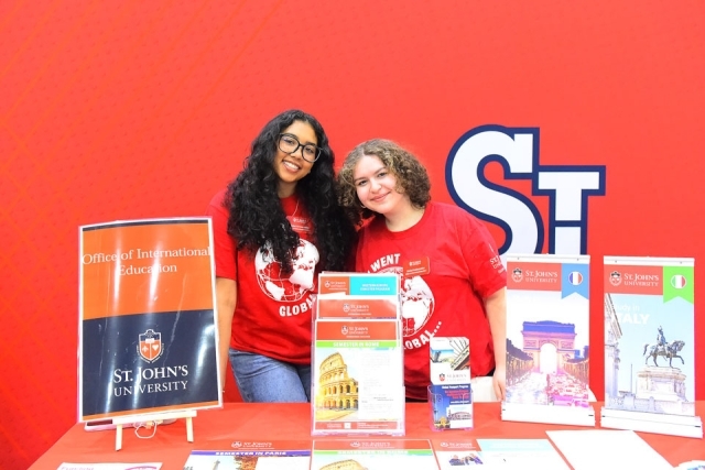 Students standing next to display 
