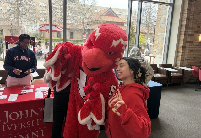 St. John's Mascot with student