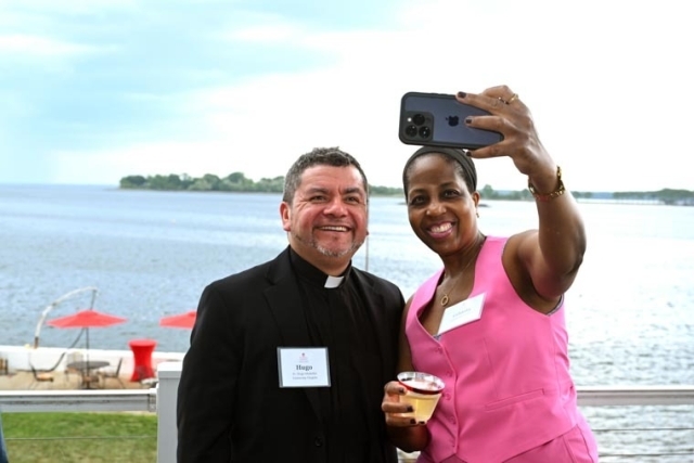 St. John's alumni taking a photo with staff