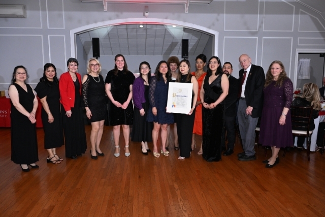 College of Pharmacy and Health Sciences faculty, students, and guests pose with a commemorative proclamation.