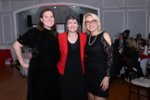 Three attendees smile for a photo during the St. John's University College of Pharmacy and Health Sciences gala.