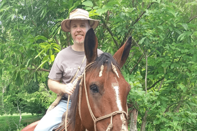 Father Fitzgerald rides a horse during a visit to the Ngäbe mission in Panama.