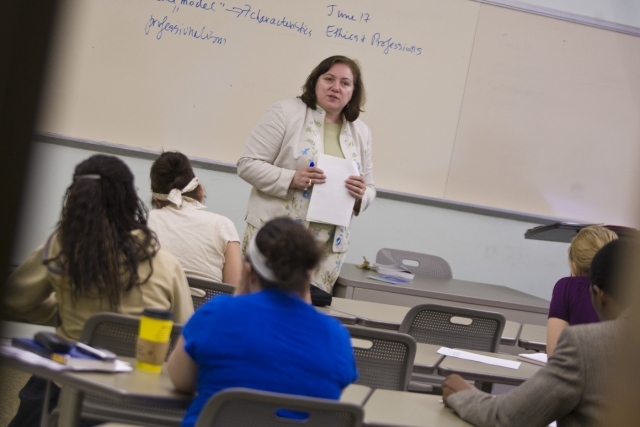 Female teaching students at desks