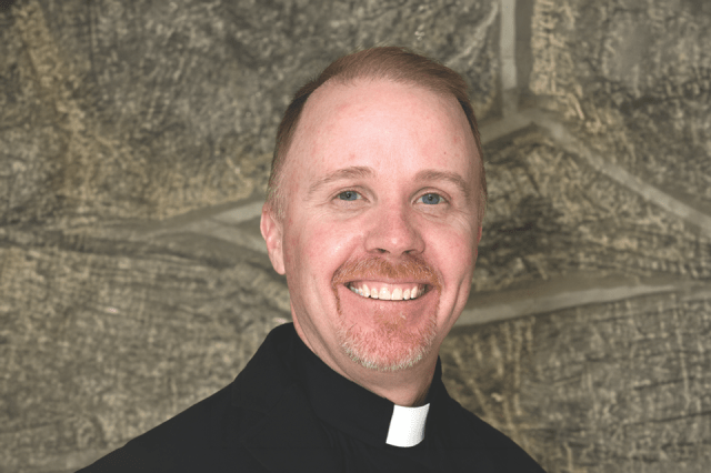 Headshot of Father Fitzgerald wearing clerical attire.