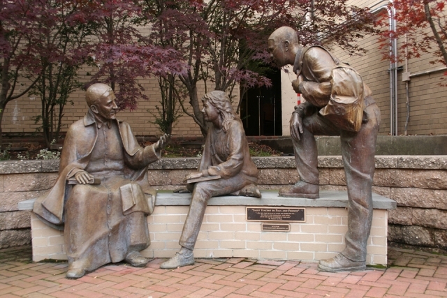 Statue of St. Vincent de Paul talking to students