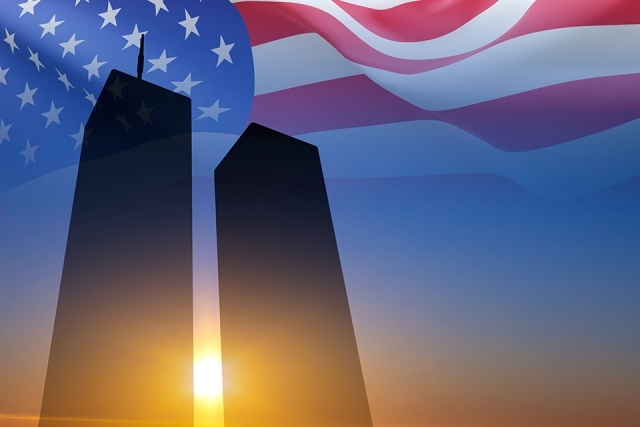The World Trade Center silhouetted by the American flag.