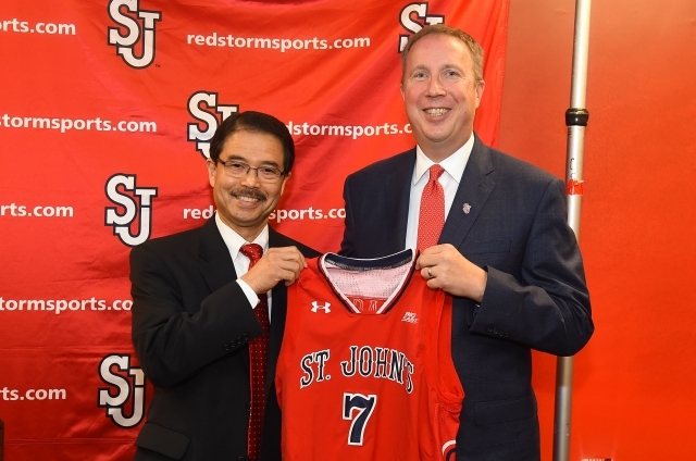 Bobby Gempesaw and Mike Cragg holding a St. John's jersey with the number 7