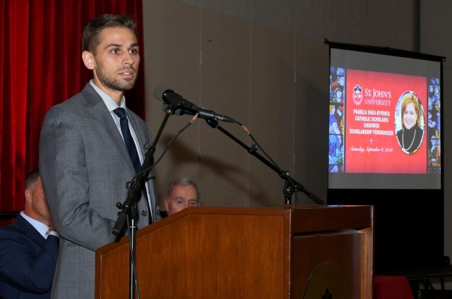 Male student speaking at podium