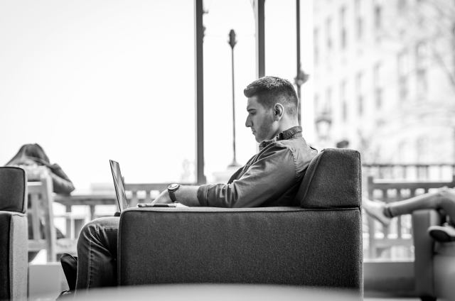 Student working at laptop in lounge