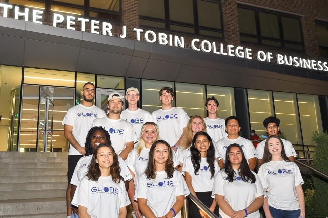 GLOBE students standing on steps of the Peter J Tobin College of Business