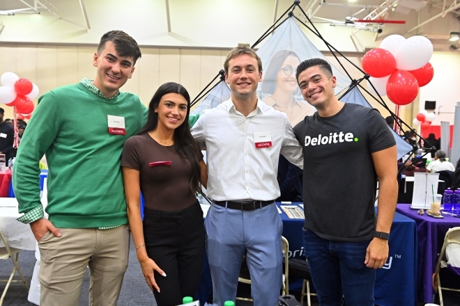 Student networking with career professionals at a career fair