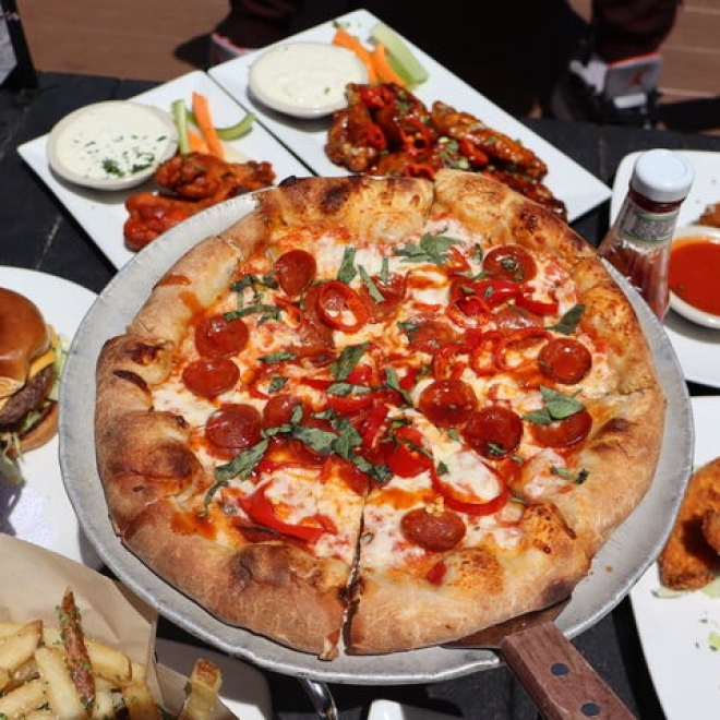 A spread of pizza and appetizers, including truffle parmesan fries and fried mozzarella, from Bourbon Street in Bayside, Queens.