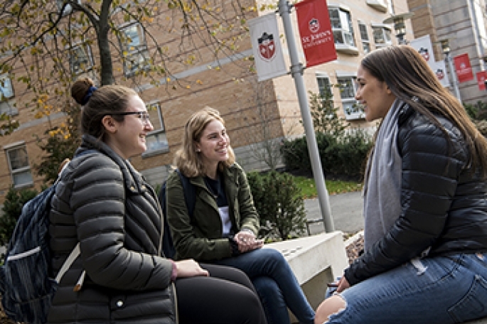 Students Sitting on Campus in the fall