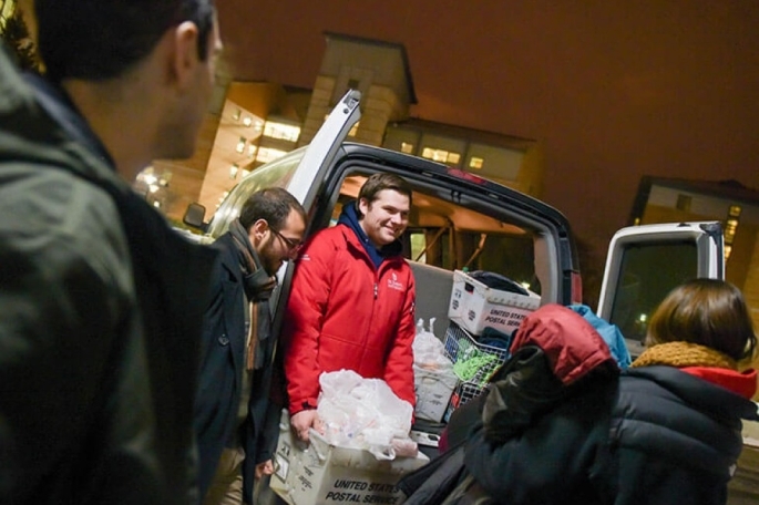 Students handing out clothes at Midnight Run