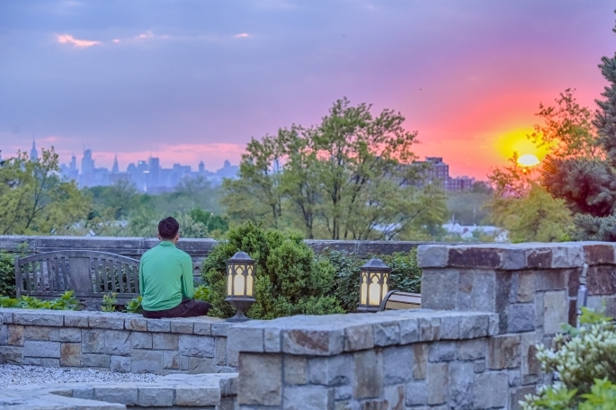 Student Overlooking NYC Skyline at St. John's