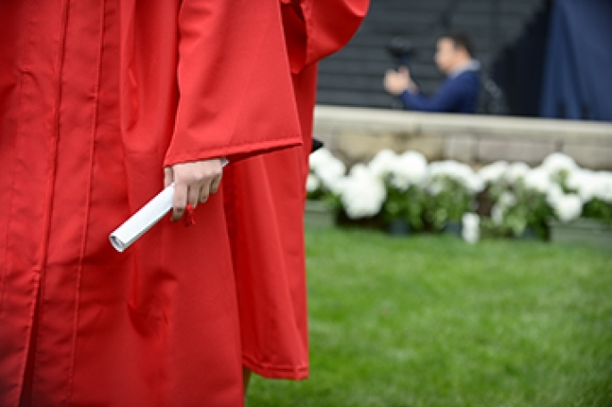 Student holding commencement scroll