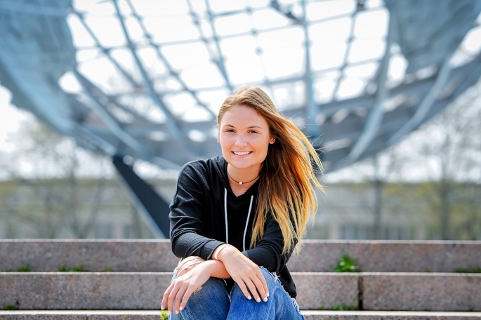 Female student infront of globe statue