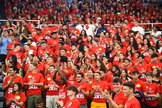 Students standing up and clapping