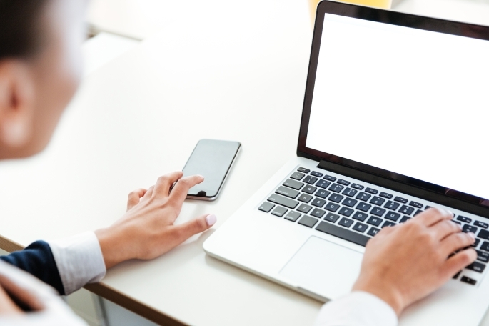 Woman Working on laptop and phone
