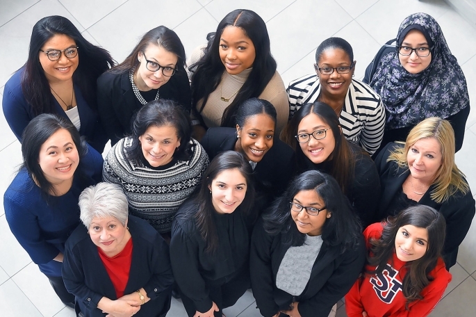 Birdseye video of group of women looking up
