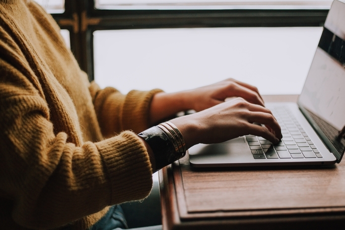 Student typing on keyboard