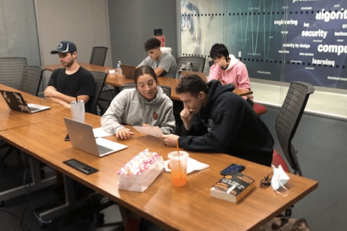 Dr. Cozine's students working on laptops together