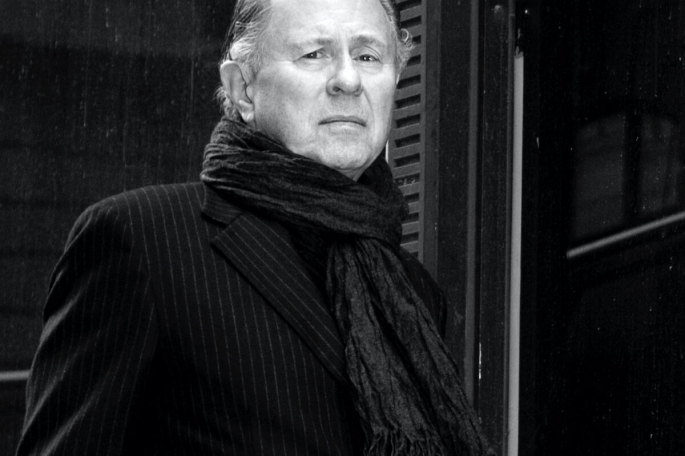 Martin Puris in a black and white image in front of a door