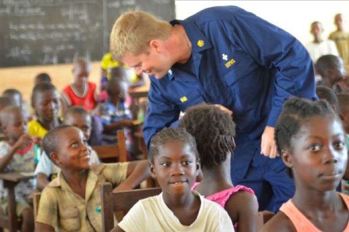 Image of young man teaching students