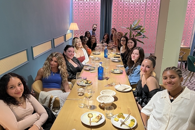Students and Max Freeman seated at long dining table in Spain