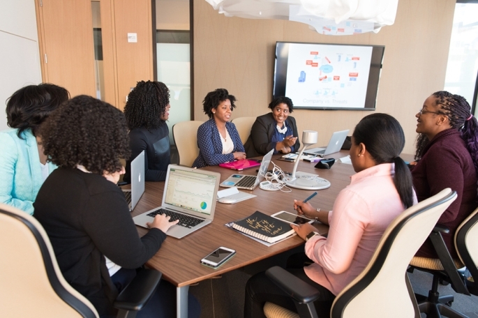 People sitting around a conference room table