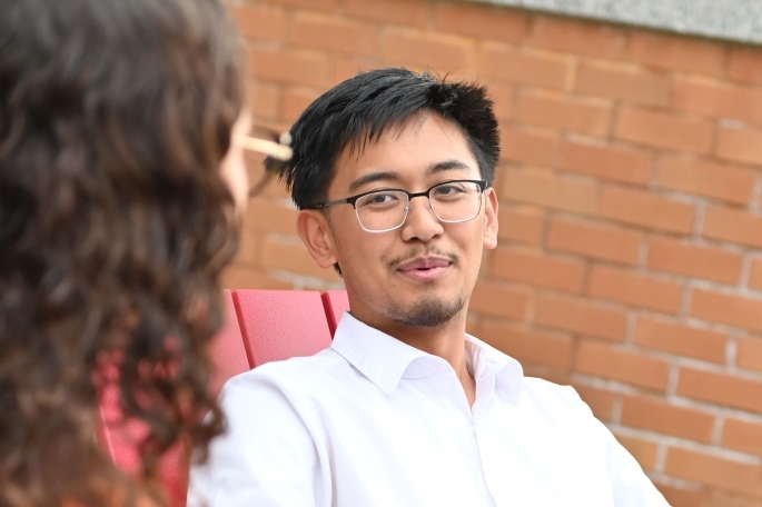Male student sitting in chair